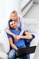 Image showing happy couple with laptop computer at home