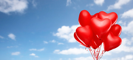 Image showing red heart shaped helium balloons on white