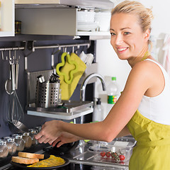 Image showing Young Mother Cooking Deliciousat Omlet at Home.