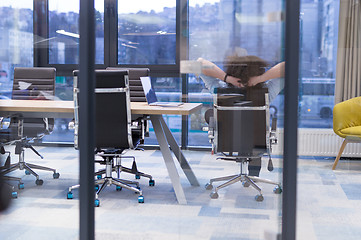 Image showing young businessman relaxing at the desk