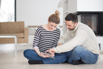 Image showing Young Couple using digital tablet on cold winter day