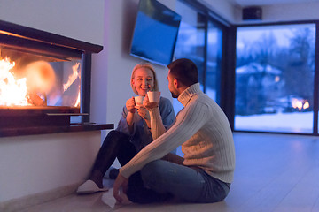 Image showing happy couple in front of fireplace