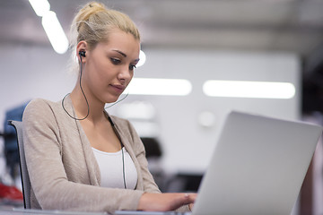 Image showing businesswoman using a laptop in startup office