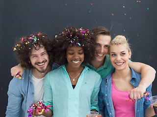 Image showing confetti party multiethnic group of people isolated over gray