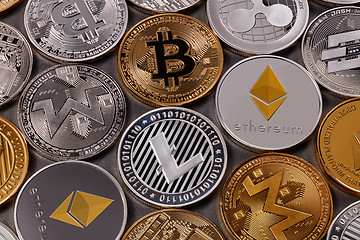 Image showing Many different coins of crypto currency on a dark background. Business and technology concept. Top view