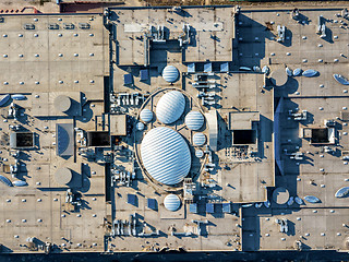 Image showing Aerial view from the drones, top view of the roof of the shopping center with ventilation outlets, antennas and roof equipment.