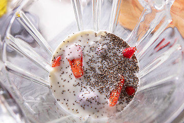 Image showing Pink smoothie in a blender with strawberries and chia seeds, view from above