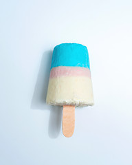 Image showing Multicolored appetizing ice cream lolly on a gray background with copy space. Top view