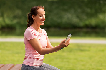 Image showing woman with smartphone at summer park