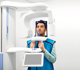 Image showing patient having x-ray scanning at dental clinic