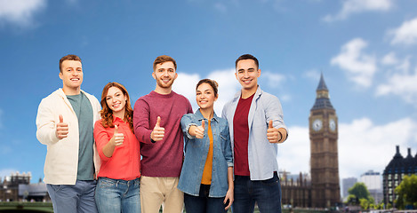 Image showing group of friends showing thumbs up over london