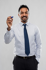 Image showing indian businessman with marker over grey