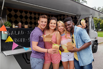 Image showing happy friends with wok and burger at food truck