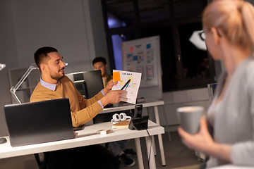 Image showing business team with papers working late at office