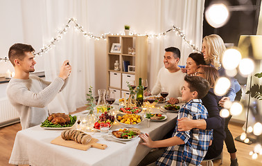 Image showing family having dinner party and taking selfie