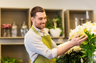 Image showing florist or seller with white lilies at flower shop