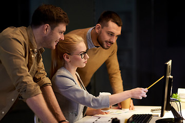 Image showing business team with computer working late at office