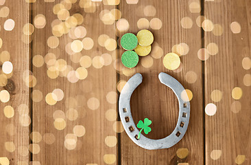 Image showing horseshoe with shamrock on wooden background