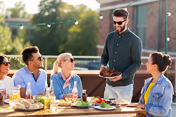 Image showing friends at bbq party on rooftop in summer