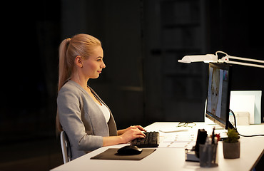 Image showing designer with computer working at nigh office