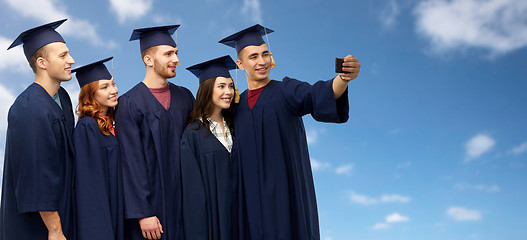 Image showing graduates taking selfie by smartphone