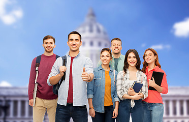 Image showing students showing thumbs up over capitol building