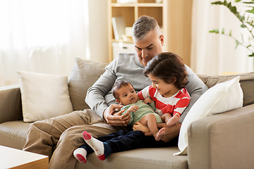Image showing happy father with preteen and baby son at home