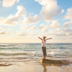 Image showing Free Happy Woman Enjoying Sunset on Sandy Beach