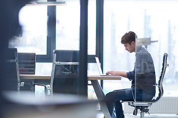 Image showing businessman working using a laptop in startup office