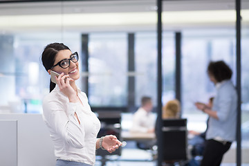 Image showing Elegant Woman Using Mobile Phone in startup office building