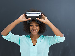 Image showing black girl using VR headset isolated on gray background