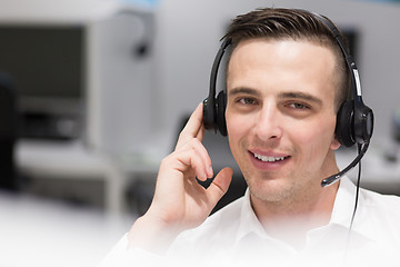 Image showing male call centre operator doing his job