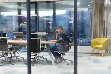 Image showing young businessman relaxing at the desk