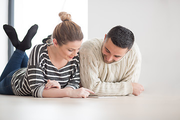 Image showing Young Couple using digital tablet on cold winter day