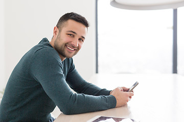 Image showing Young casual businessman using smartphone