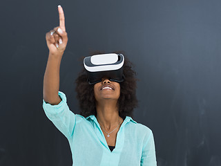 Image showing black girl using VR headset isolated on gray background