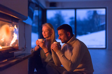 Image showing happy couple in front of fireplace