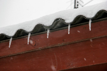 Image showing Brown house roof with icicles.