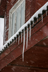 Image showing Brown house roof with icicles.