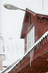 Image showing Brown house roof with icicles.