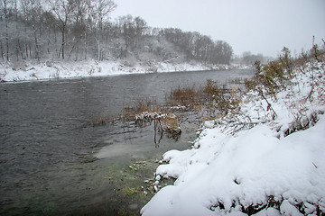 Image showing Snow covered landscape with forest and riwer during the winter.