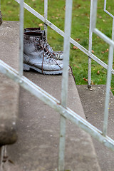 Image showing Dirty old workboots on stairs.