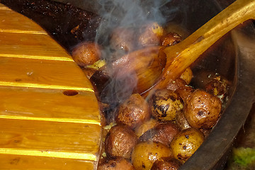 Image showing Potatoes with peel in pan in outdoor. 