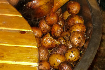 Image showing Potatoes with peel in pan in outdoor. 