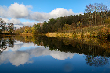 Image showing Autumn landscape with colorful trees and river. Reflection in ri