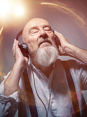 Image showing elderly bald head man with headphones