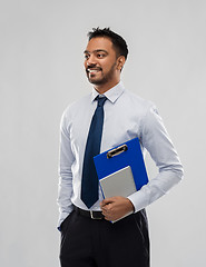 Image showing indian businessman with clipboard and notebook