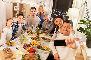 Image showing family having dinner party and taking selfie