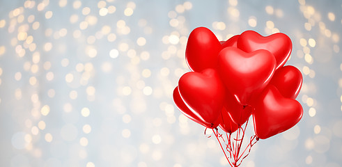 Image showing red heart shaped helium balloons on white