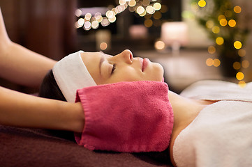 Image showing woman having face massage with terry gloves at spa